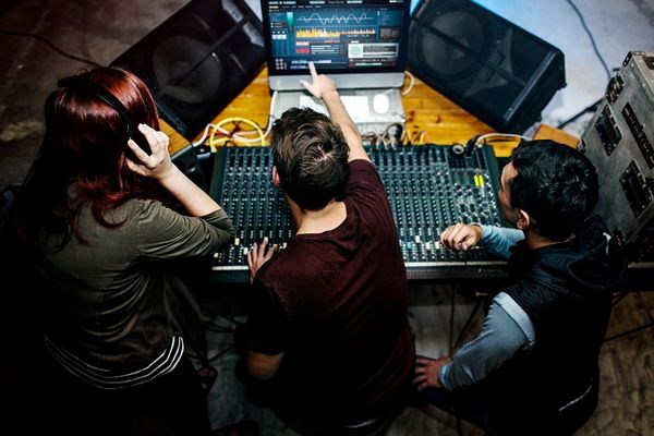 Group of people at a sound mixer station